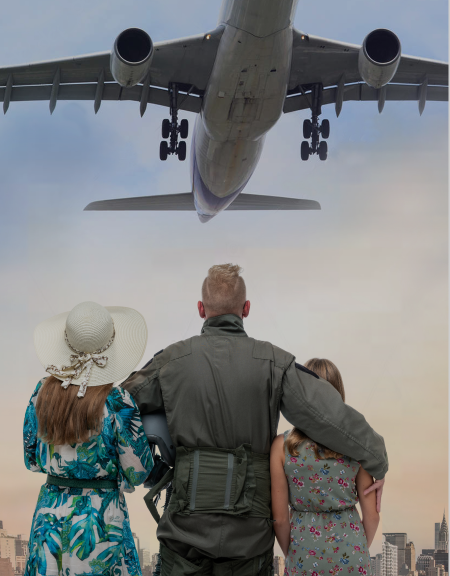 Family hugging, looking at airplane flying overhead.